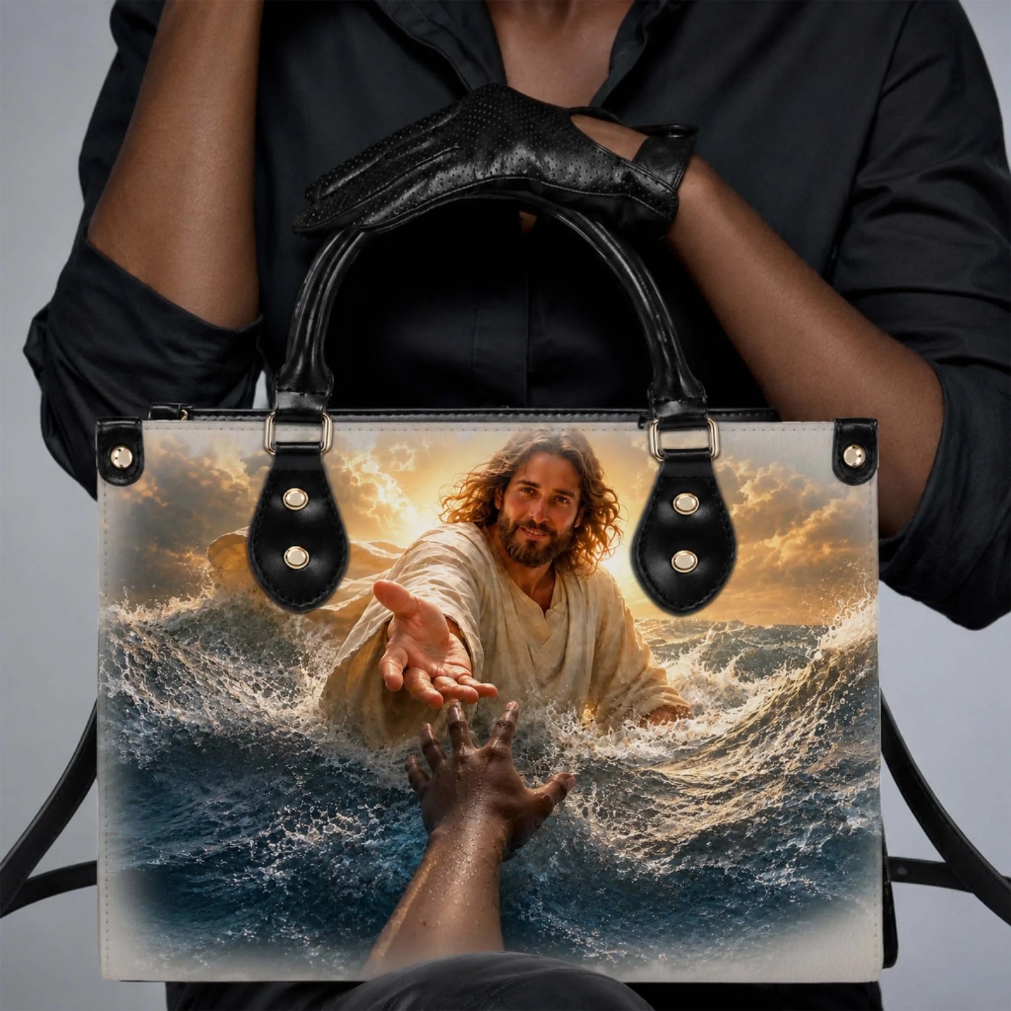 A woman holding a personalized PU leather tote bag with a religious design of Jesus reaching out over the waves.