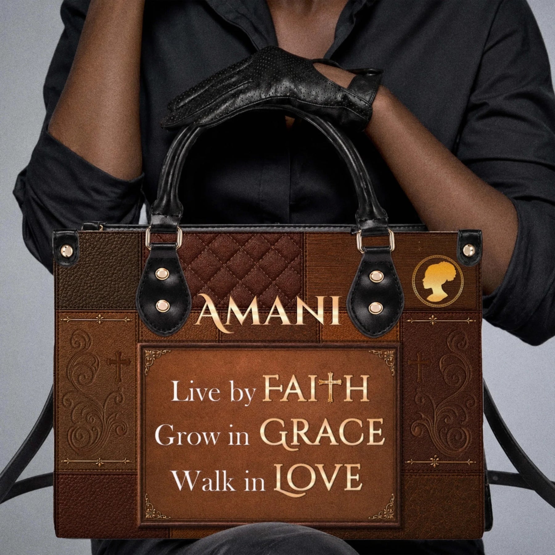 A woman wearing black clothes holding a brown personalized handbag with the text Amani and religious inspirational quotes.