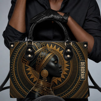 A woman wearing black clothes holding a stylish personalized tote bag with a striking African queen graphic art.