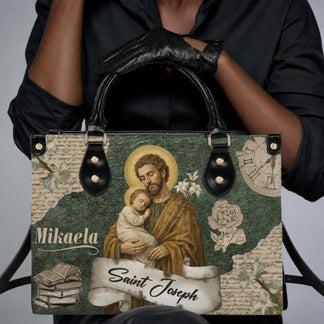 A woman holding a custom Mikaela Saint Joseph religious print handbag with black leather handles and trim.