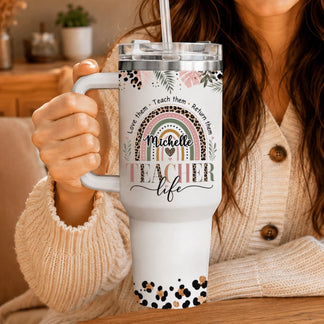 Woman holding a custom teacher tumbler with leopard print rainbow design and Michelle name, great back to school gift.